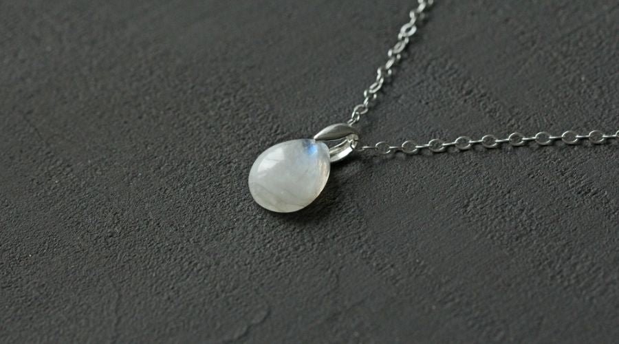moonstone necklace on wood table