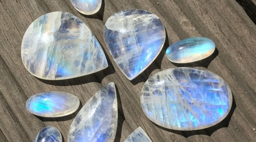 different shaped moonstones on a wooden table