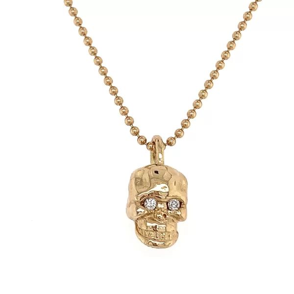 solid gold skull charm with diamond eyes